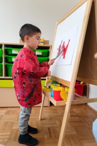 Child painting at daycare holiday camp at Big Ben Kids International Childcare