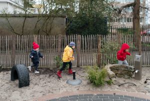 Children playing outside in the garden at the after school care
